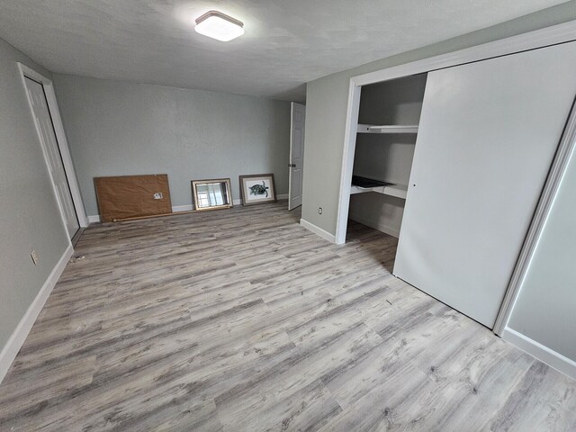 unfurnished bedroom featuring light hardwood / wood-style floors and a closet