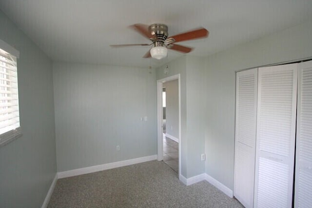 unfurnished bedroom featuring ceiling fan, carpet floors, and a closet