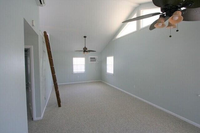 spare room with ceiling fan, light colored carpet, high vaulted ceiling, and an AC wall unit