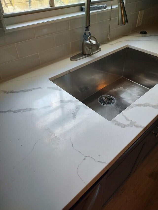 room details featuring sink and decorative backsplash