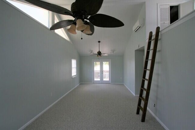 unfurnished room with vaulted ceiling, an AC wall unit, light colored carpet, ceiling fan, and french doors