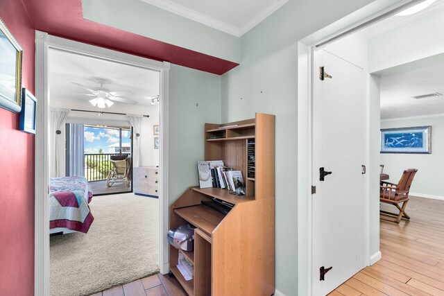 interior space featuring ornamental molding and light hardwood / wood-style floors