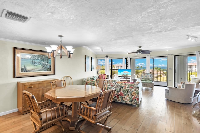 dining area with crown molding, ceiling fan with notable chandelier, a textured ceiling, and light hardwood / wood-style flooring