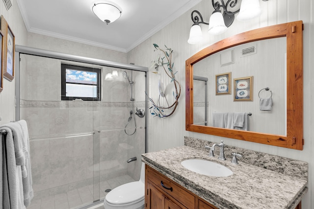 bathroom featuring vanity, crown molding, toilet, and walk in shower