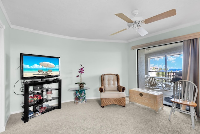 sitting room with ornamental molding, carpet, and ceiling fan