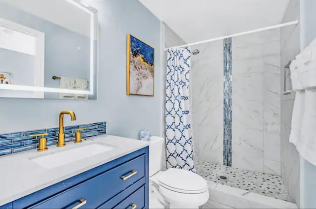 bathroom featuring vanity, toilet, and walk in shower