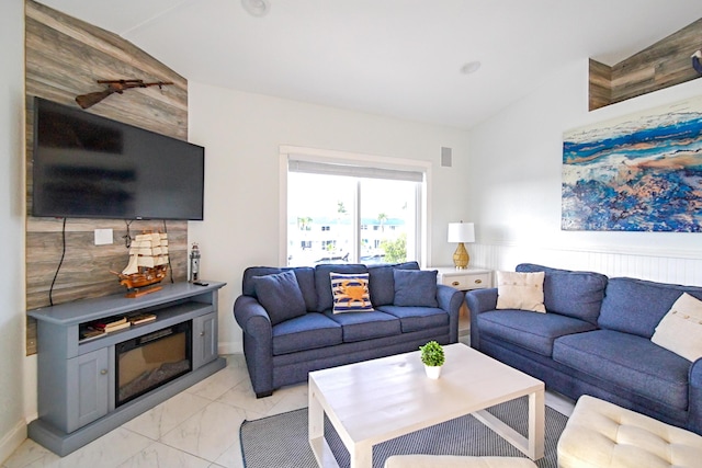 living room featuring lofted ceiling