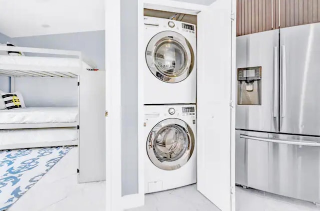 washroom featuring stacked washer / dryer