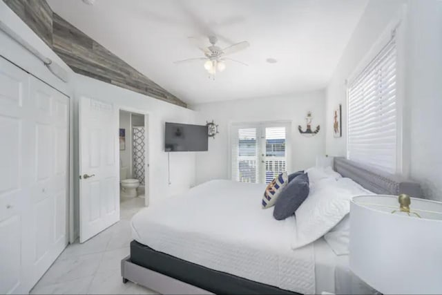 bedroom featuring ensuite bath, vaulted ceiling, and ceiling fan