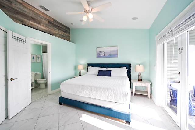 bedroom with ensuite bath, vaulted ceiling, and ceiling fan