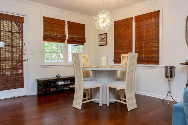 dining room with crown molding, dark hardwood / wood-style floors, and a chandelier