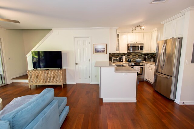 kitchen featuring white cabinetry, tasteful backsplash, stainless steel appliances, and dark hardwood / wood-style floors