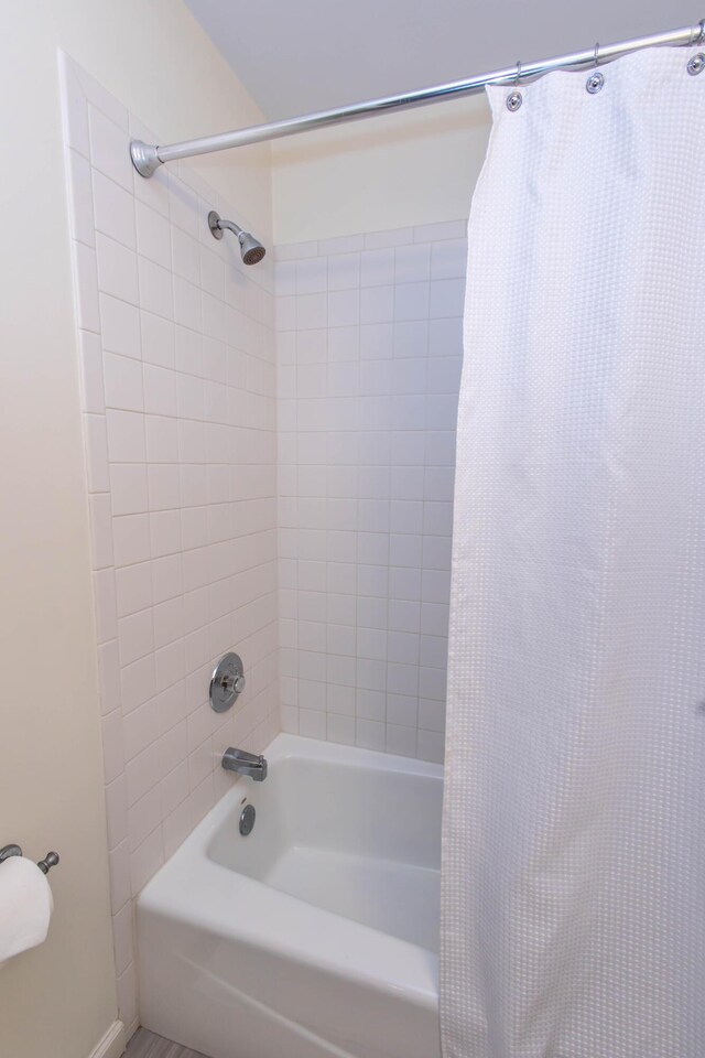 bathroom with shower / bathtub combination with curtain