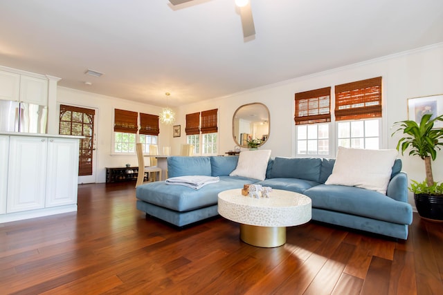 living room with ornamental molding, ceiling fan, and dark hardwood / wood-style flooring