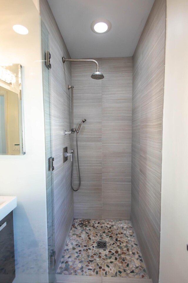 bathroom featuring vanity and a shower with shower door