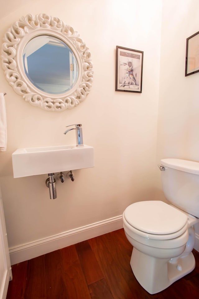 bathroom with sink, hardwood / wood-style flooring, and toilet