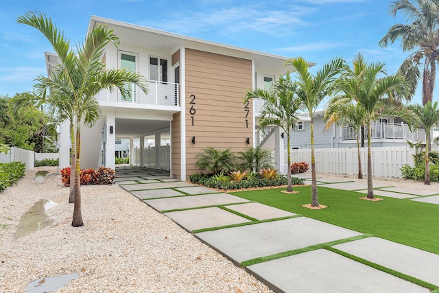 view of front of property featuring a carport and a balcony