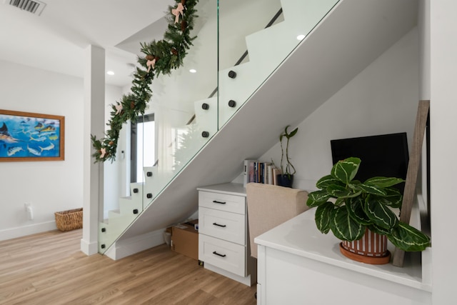 stairs with hardwood / wood-style floors