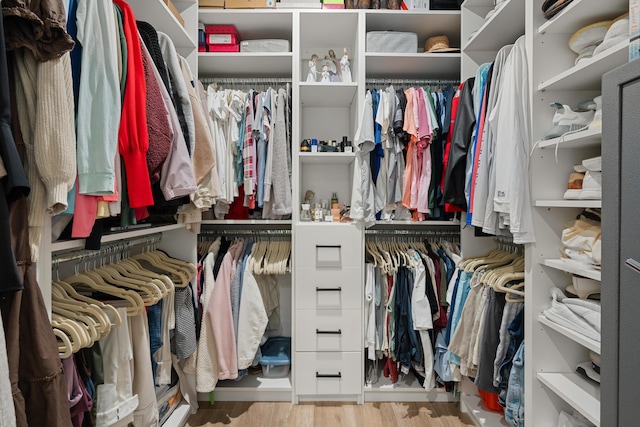 spacious closet with light hardwood / wood-style floors