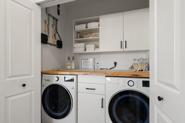 laundry area with cabinets and washing machine and dryer