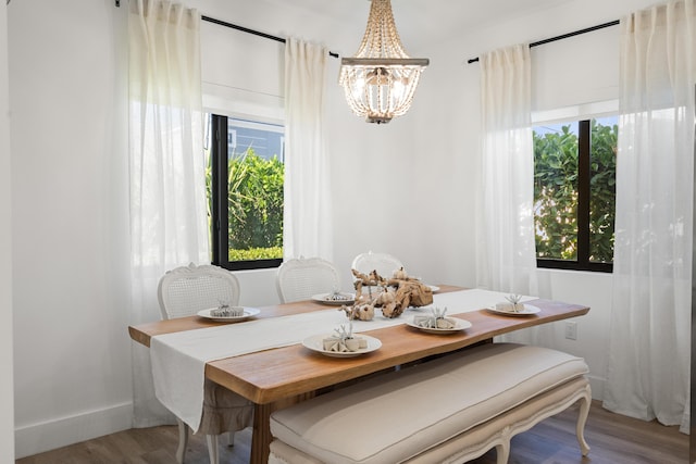 dining space featuring a notable chandelier and wood-type flooring