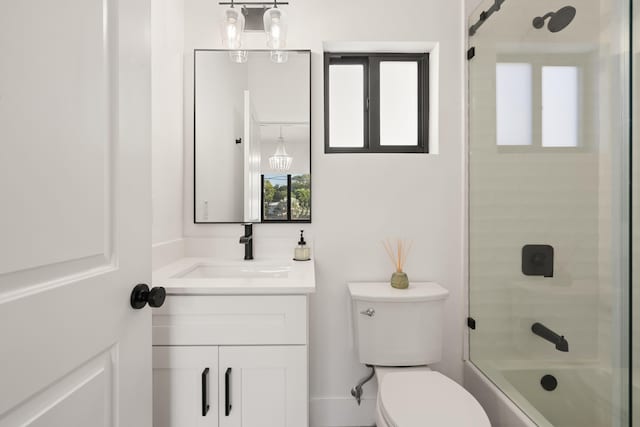 full bathroom with vanity, tiled shower / bath combo, and toilet