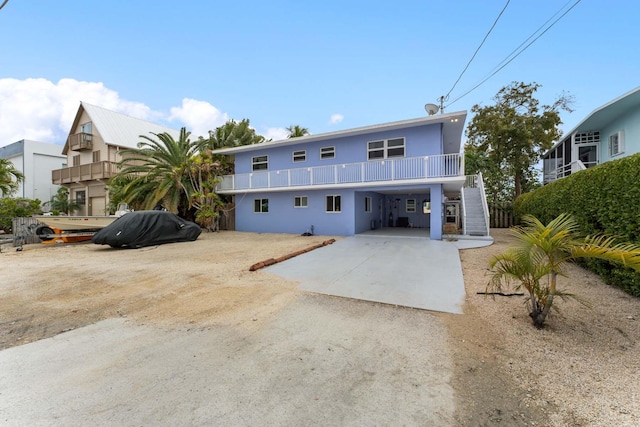 view of front of house with a carport and a balcony