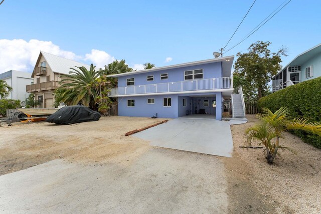 view of front of house with a carport and a balcony