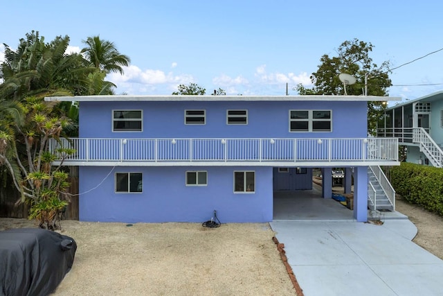 back of property featuring a carport