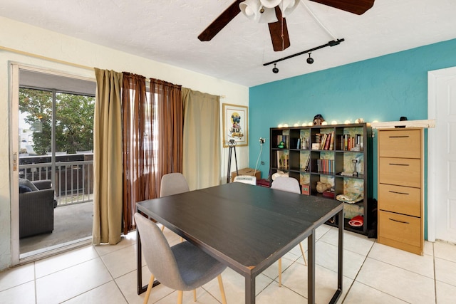 dining room with ceiling fan, rail lighting, a textured ceiling, and light tile patterned floors