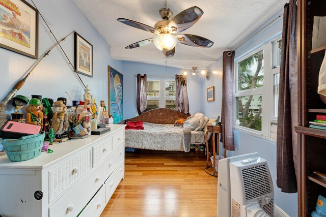 bedroom featuring multiple windows, ceiling fan, and light hardwood / wood-style floors