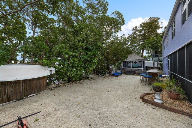 view of yard featuring a gazebo and a swimming pool