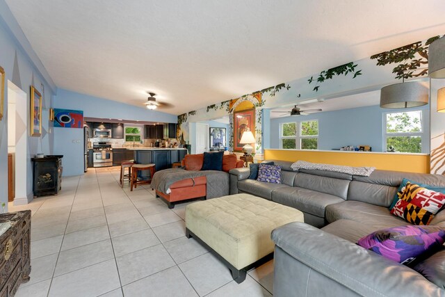 tiled living room with vaulted ceiling and ceiling fan