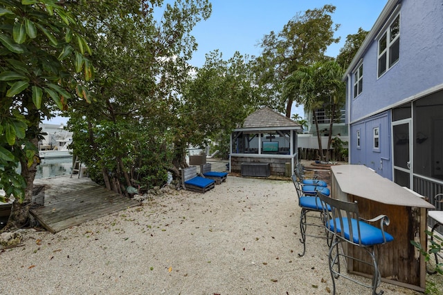 view of yard featuring a gazebo and an outdoor bar