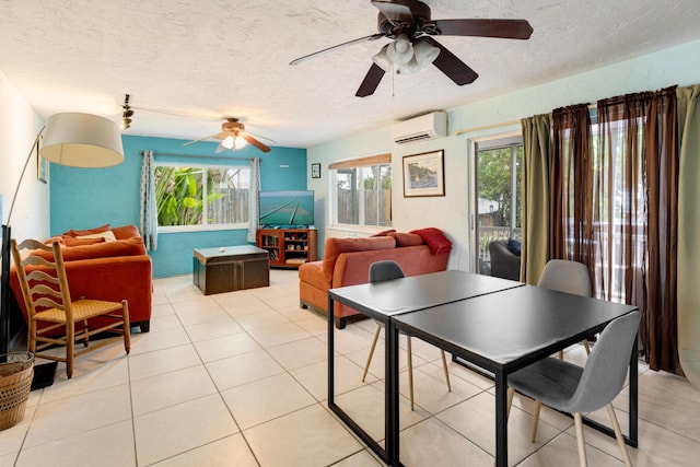 dining area with ceiling fan, light tile patterned floors, a textured ceiling, and a wall unit AC