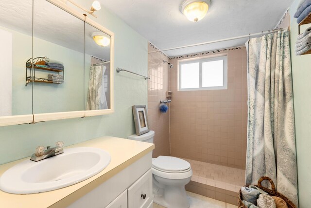 bathroom with vanity, tile patterned flooring, toilet, and a shower with shower curtain