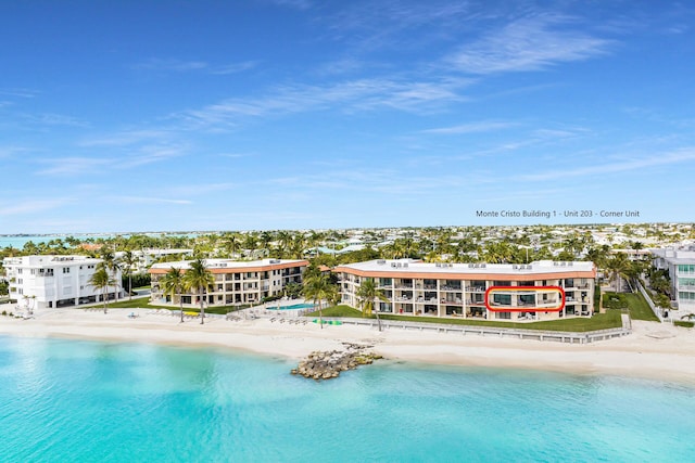 exterior space featuring a water view and a view of the beach