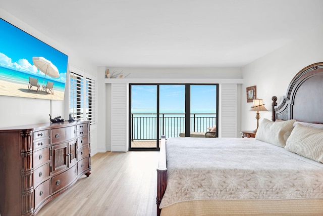 bedroom with access to exterior and light wood-type flooring