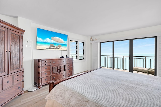 bedroom featuring access to exterior and light hardwood / wood-style floors