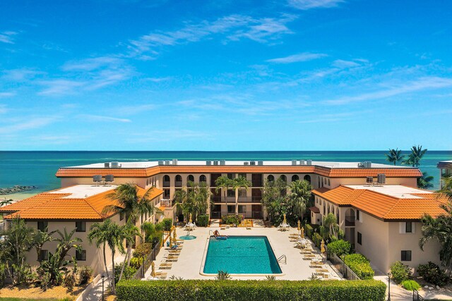 exterior space with a water view and a patio