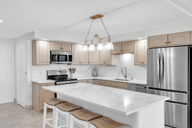 kitchen featuring backsplash, a kitchen island, a breakfast bar, and appliances with stainless steel finishes