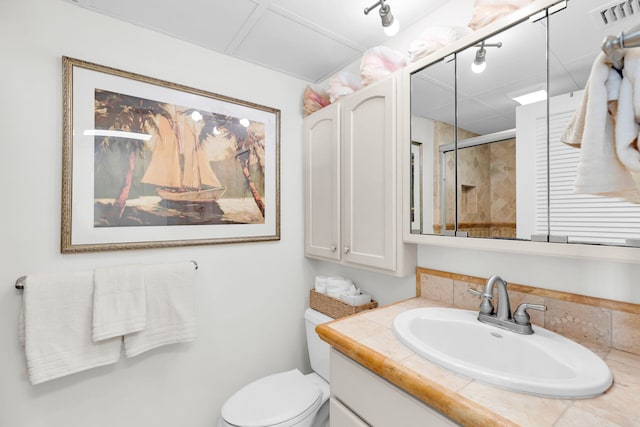 bathroom with vanity, a shower with shower door, and toilet