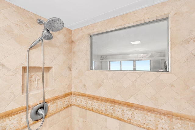 interior details with a tile shower