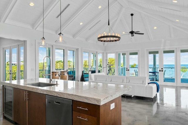 kitchen featuring a water view, dishwasher, sink, and french doors