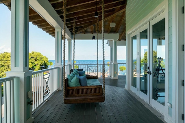 balcony with french doors and a water view