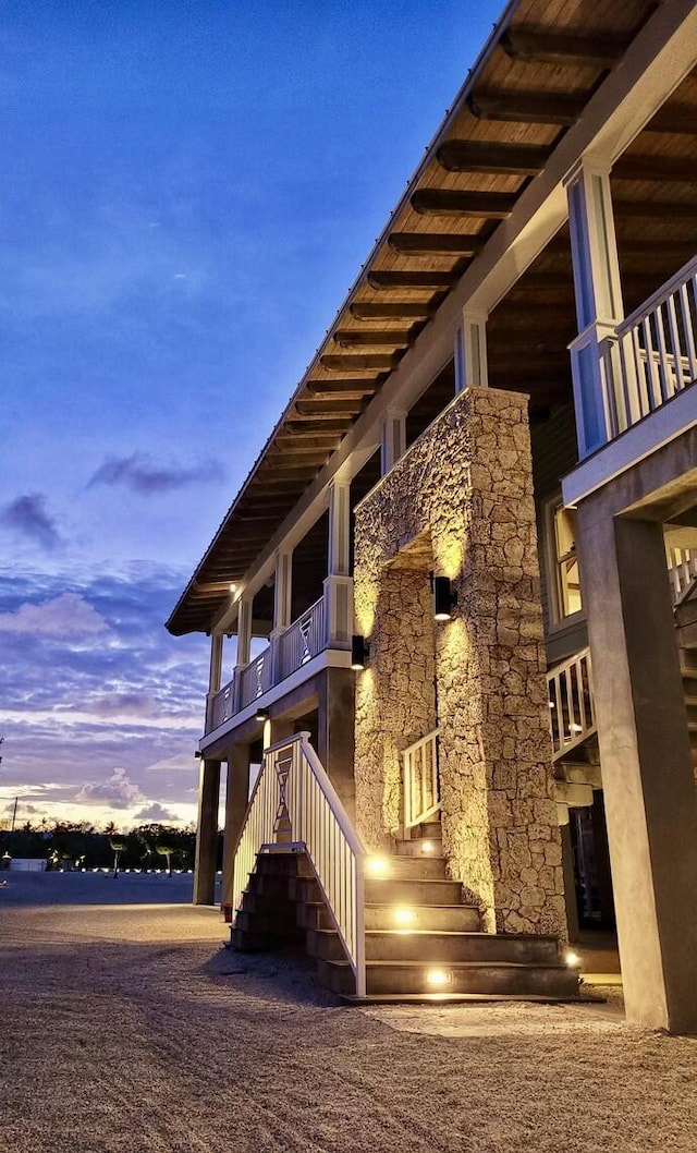 property exterior at dusk featuring a water view