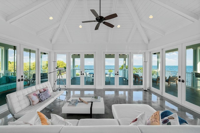 sunroom with plenty of natural light, lofted ceiling with beams, french doors, and a water view