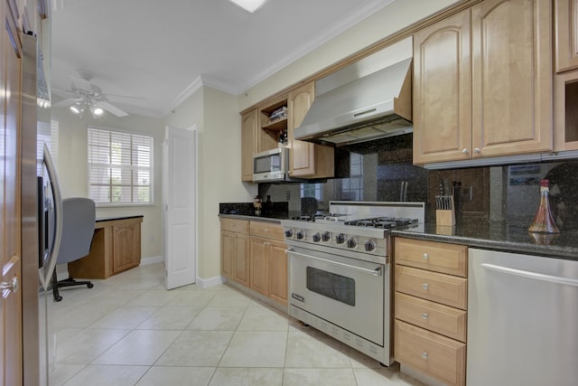 kitchen with wall chimney range hood, crown molding, appliances with stainless steel finishes, dark stone countertops, and backsplash