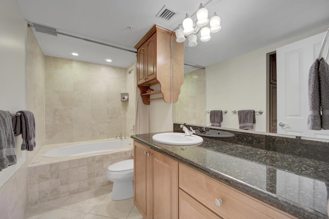 full bathroom featuring tiled shower / bath, vanity, toilet, and tile patterned flooring