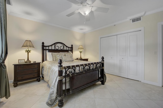 bedroom with ornamental molding, light tile patterned floors, and a closet